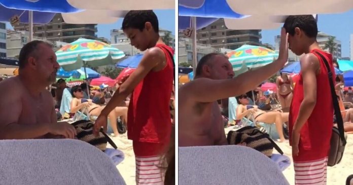 Homem passa protetor solar em menino que vendia bala na praia sob sol escaldante