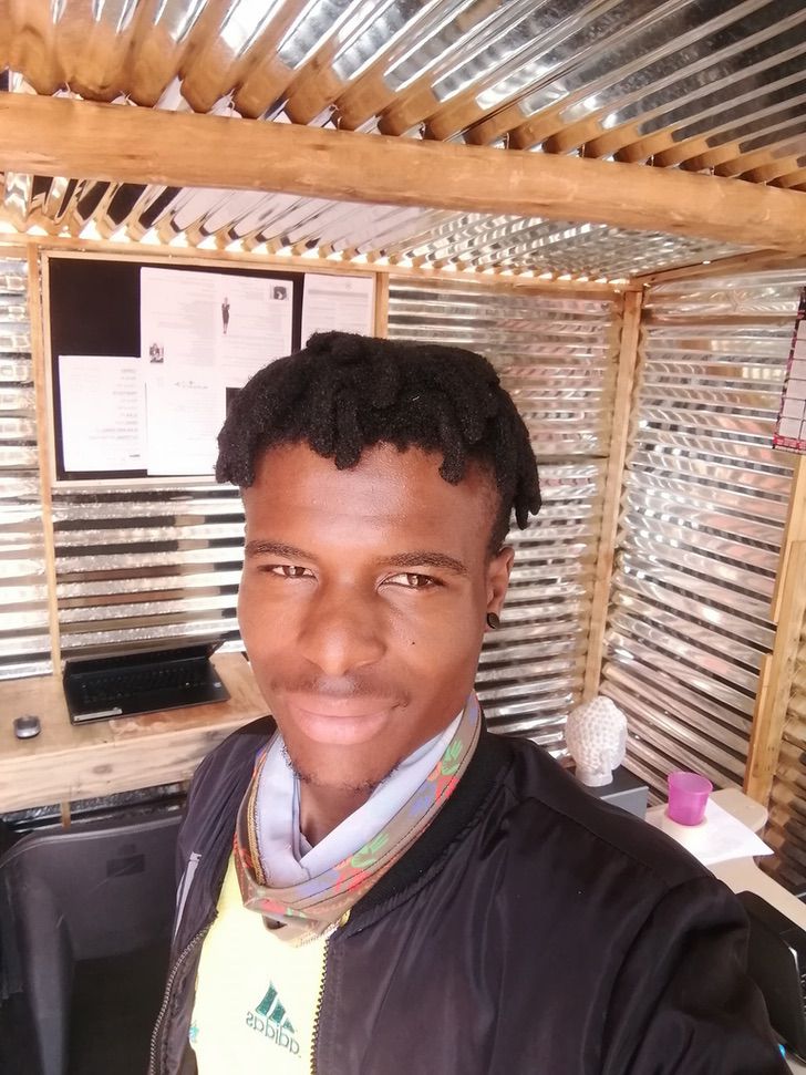 psicologiasdobrasil.com.br - Jovem africano posa com orgulho após abrir cibercafé em uma barraca. Na sua região, a internet é um luxo
