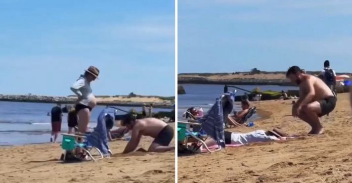 Ele cavou um buraco na praia para que sua esposa grávida pudesse se deitar